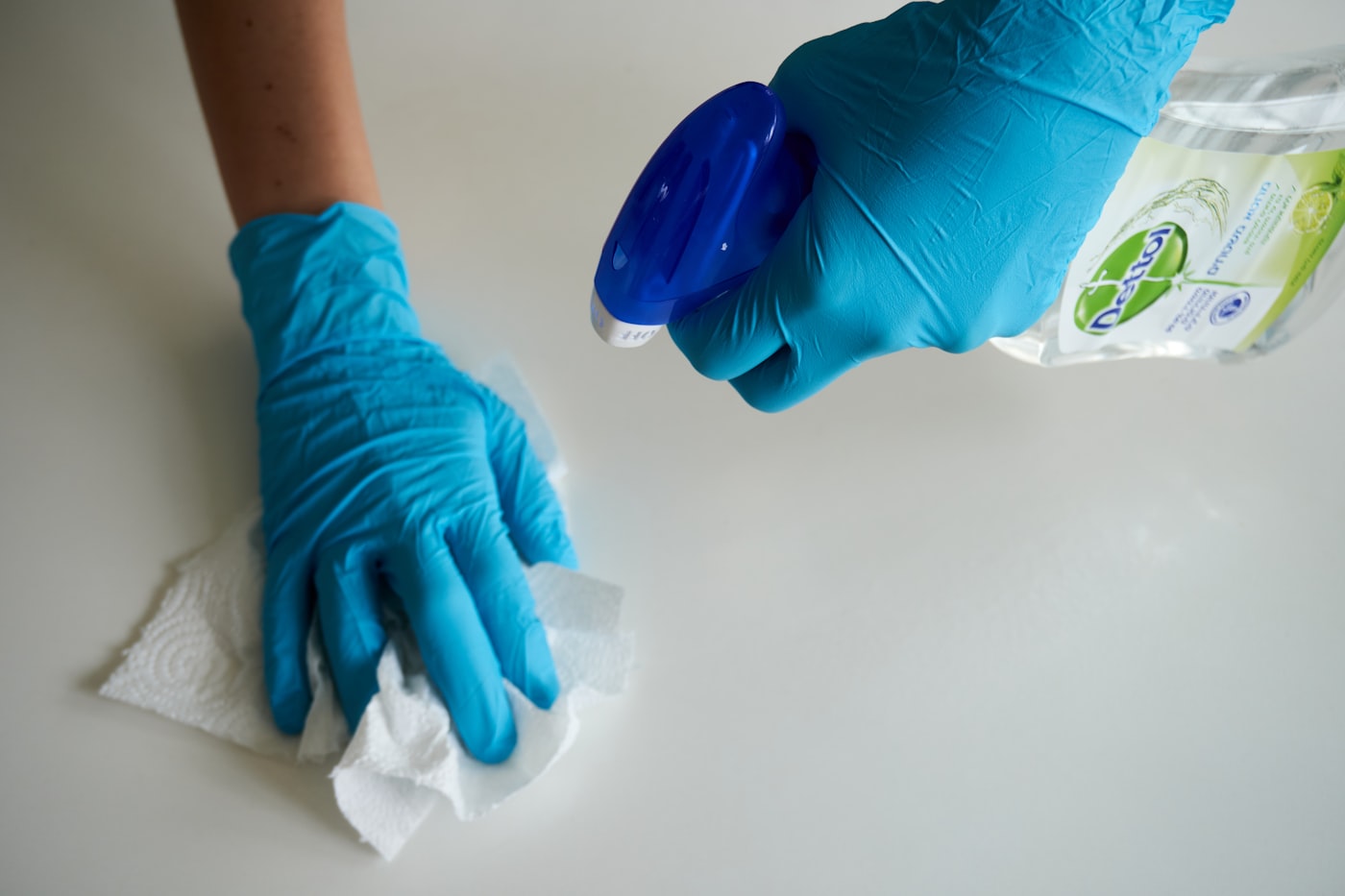 Gloved hand spraying eco-friendly cleaner